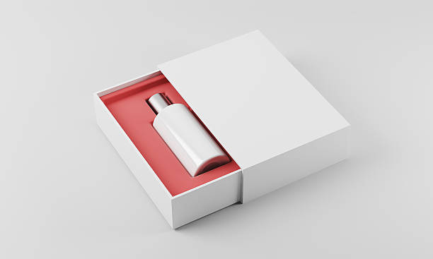 White and silver bottle of perfume in white and red box lying on white surface.